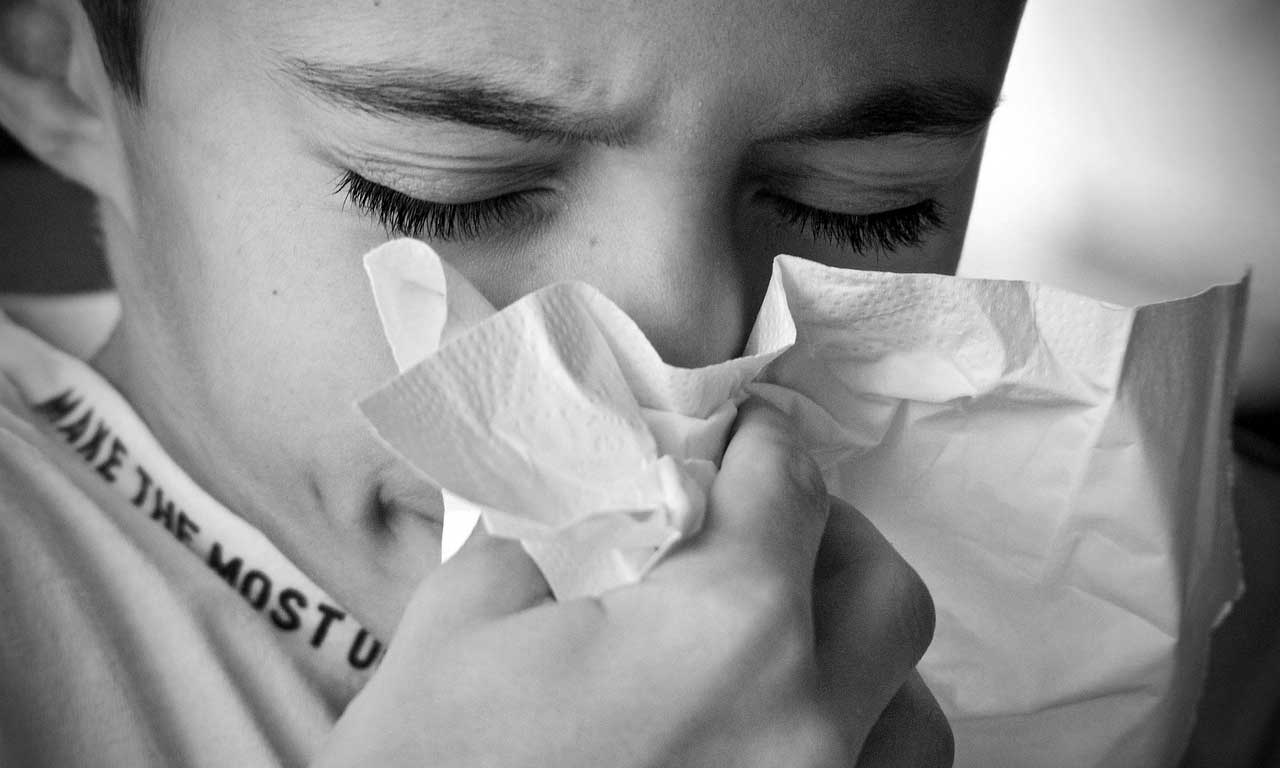 boy blowing nose image
